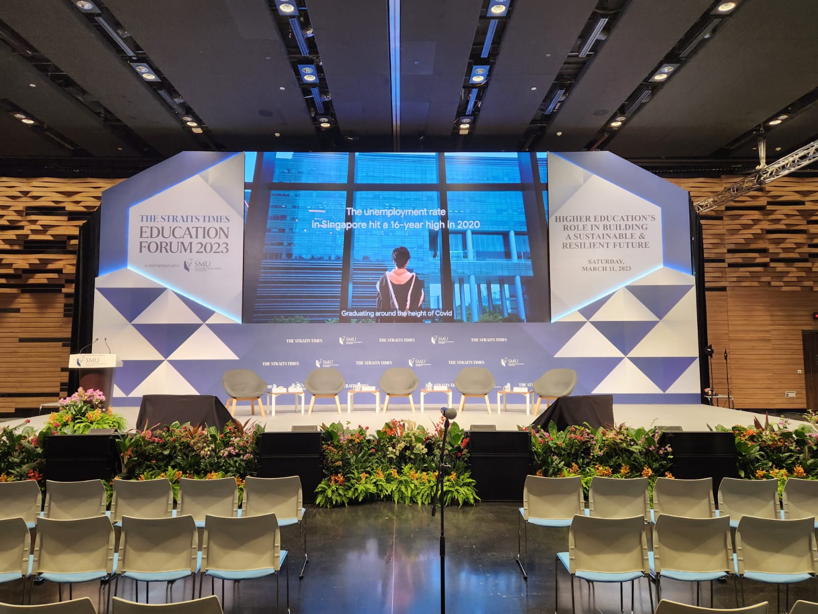 Corporate conference stage with full AV production and seated audience