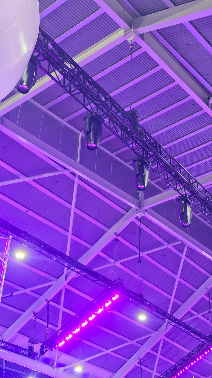 Close-up of aluminium truss rigging with moving-head fixtures loaded for a Singapore live event
