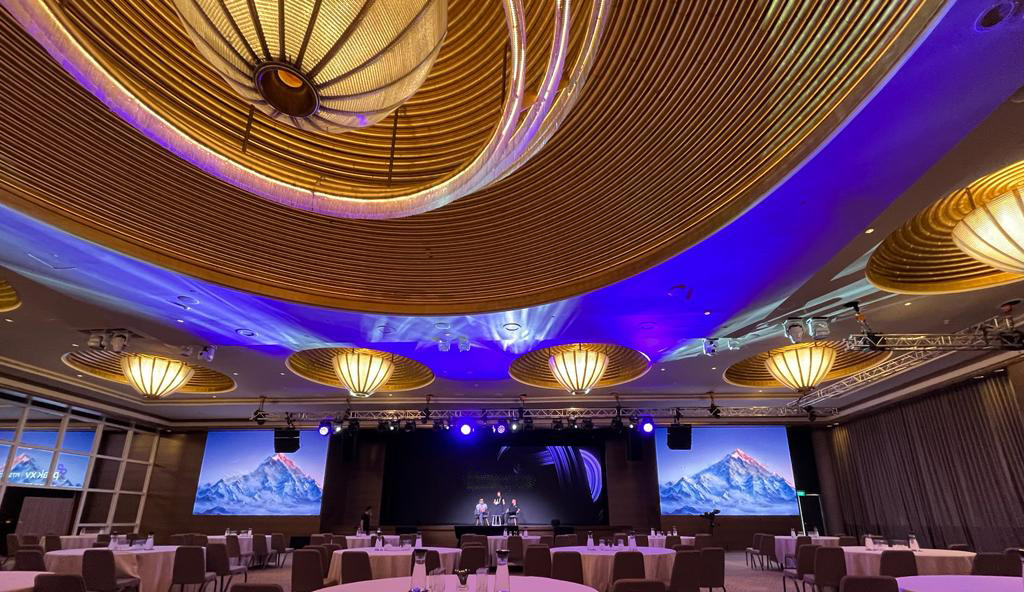 Corporate event stage with professional lighting rig and audience seating Singapore